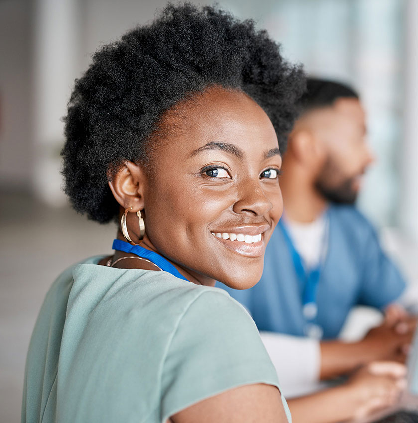 Materials Manager looking back at camera from computer